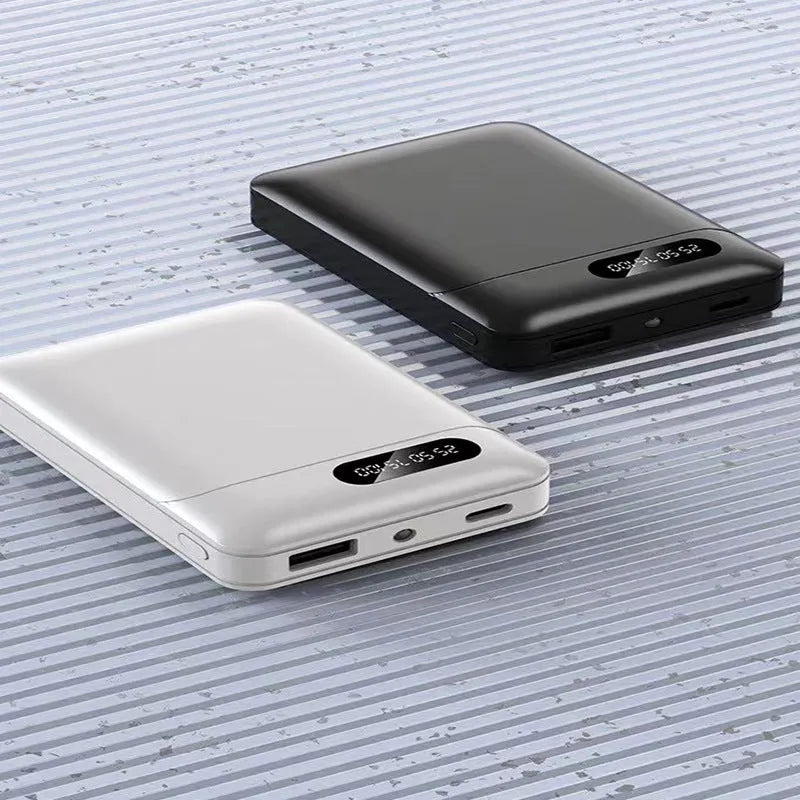 Black and white portable power bank with multiple capacity options and USB ports on a grey background.