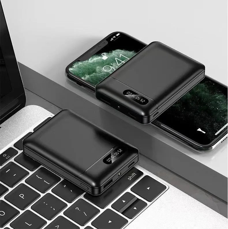 Black and white portable power bank with multiple capacity options and USB ports on a grey background.