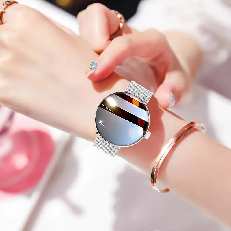Female smart watch with circular dial, metal strap, and color screen showing heart rate data