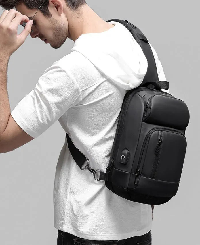 Black PVC outdoor shoulder bag with air cushion strap showing internal laptop and phone compartments