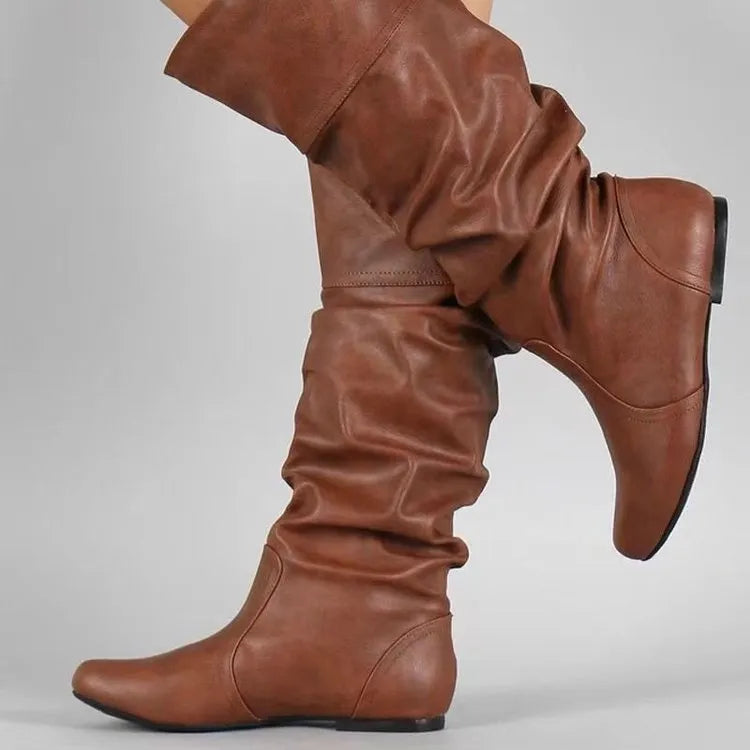 Women's black slip-on flat high cylinder boots with a round toe and rubber sole.