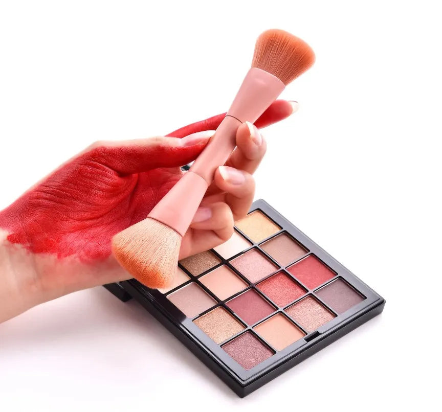 Ten professional makeup brushes with wooden handles arranged in a set, including powder, foundation and detail brushes