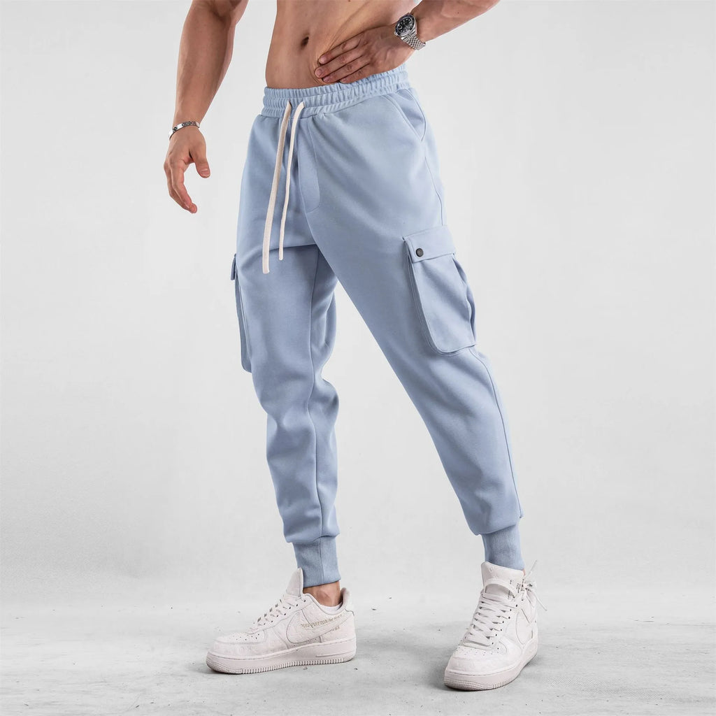 Men's loose fit multi-pocket cotton trousers with ankle ties in apricot colour