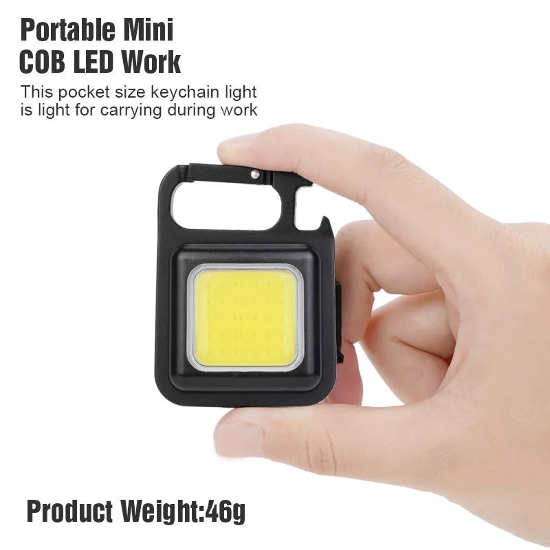 Black aluminium alloy USB rechargeable keychain light with LED, magnet, and folding handle