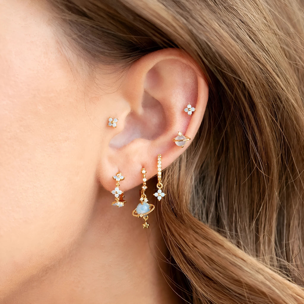 Gold and silver floral stud earrings with blue protein flower nail and zircon mosaic detail.