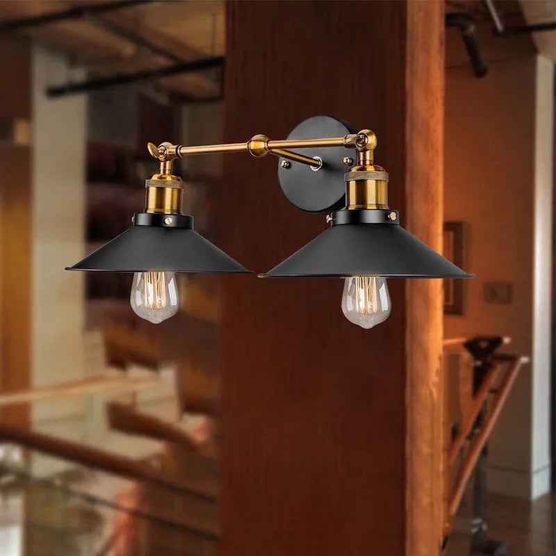 Black iron retro industrial style wall lamp with two adjustable light heads.