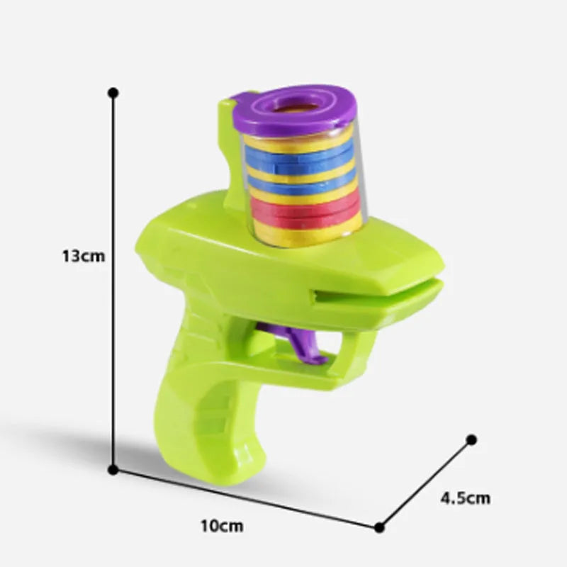 Green durable plastic battery-free cat toy launcher with a foam disc on a wooden floor.