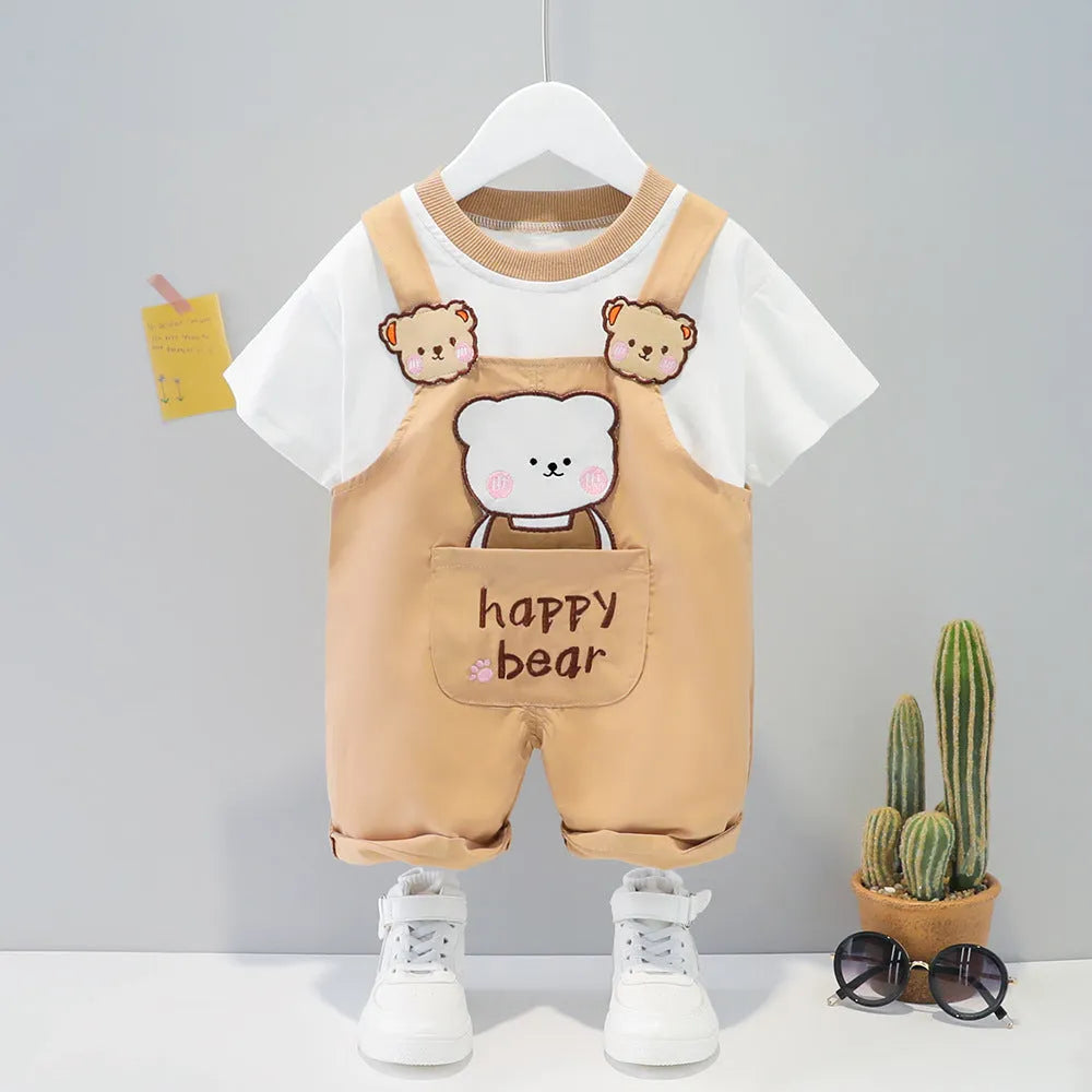 Baby wearing yellow cotton short-sleeved overalls with a cartoon print and openable straps.