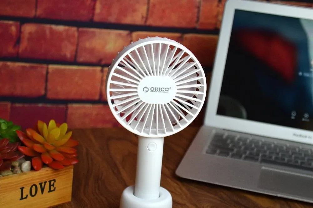 White ORICO FH1 portable USB rechargeable desk fan showing three-speed buttons and compact design