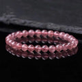 Women's strawberry quartz crystal bracelet showing 10mm, 8mm and 6mm polished beads