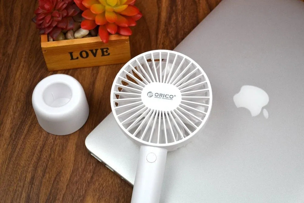 White ORICO FH1 portable USB rechargeable desk fan showing three-speed buttons and compact design
