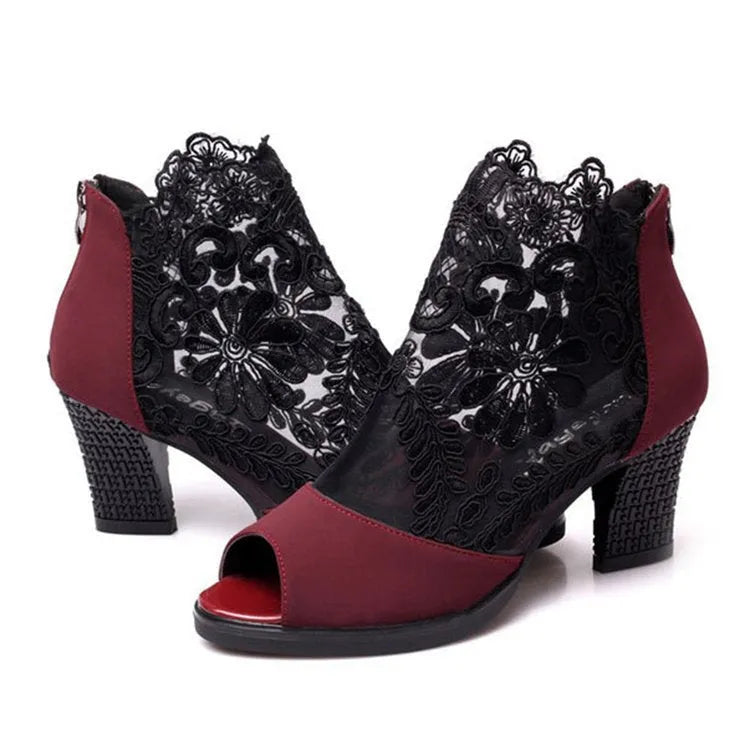 Women's black gladiator sandals with square heels and flower lace upper showing zip closure detail
