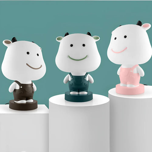 Cartoon animal table lamp in bear, cow, rabbit, or tiger design with plastic shade and LED light.