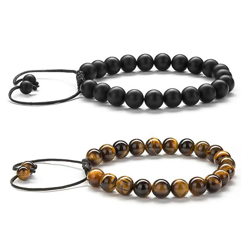 Matte black agate tiger eye bead couple bracelets with geometric design on a neutral background.