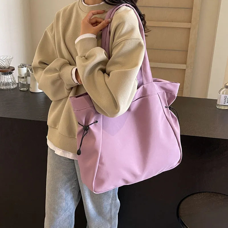Oxford cloth folding tote bag in five colour options: black, brown, dark grey, light grey and purple.