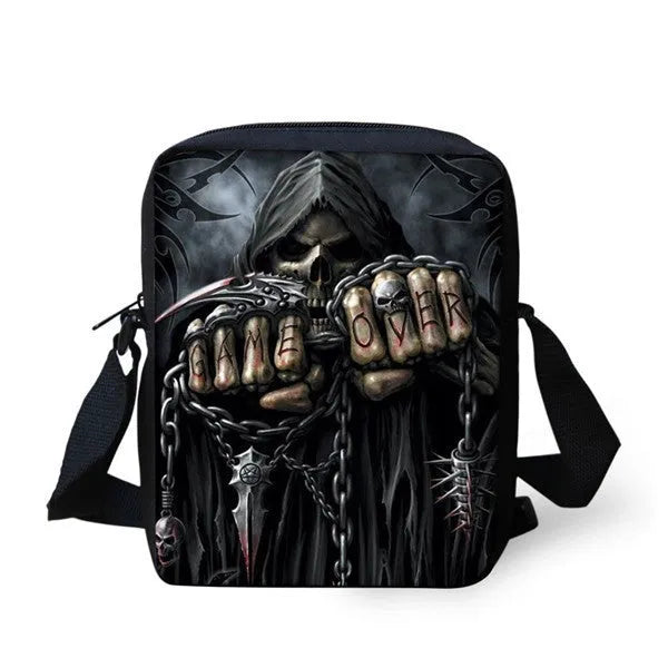 A medium-sized black children's messenger bag with a white skull graphic, showing the double straps and front zipper pocket.