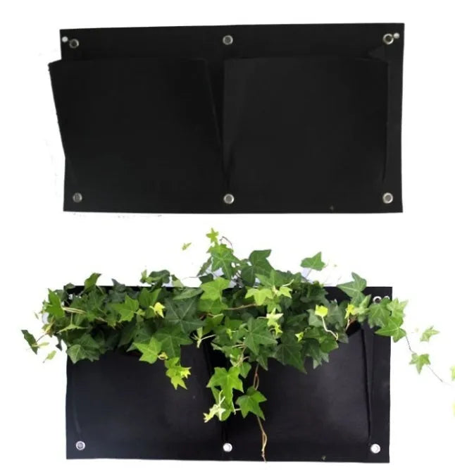Green recycled felt vertical wall planter with multiple pockets hung on an outdoor fence.