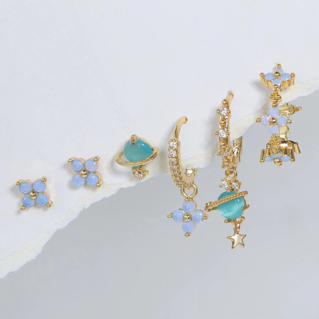 Gold and silver floral stud earrings with blue protein flower nail and zircon mosaic detail.