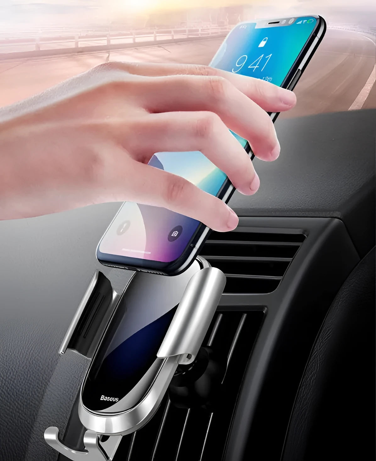 Universal smart car bracket in black mounted on a car dashboard holding a smartphone