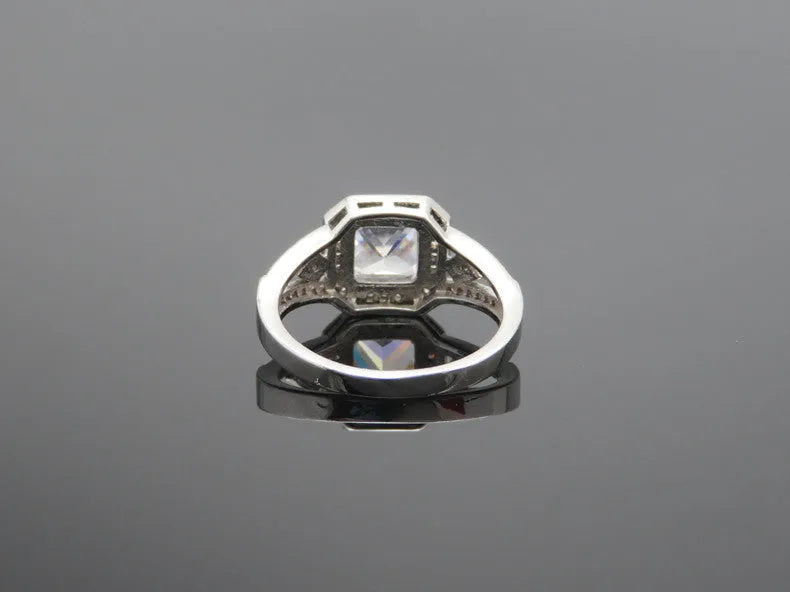 Platinum colour geometric zircon ring with hollow quadrilateral design on finger
