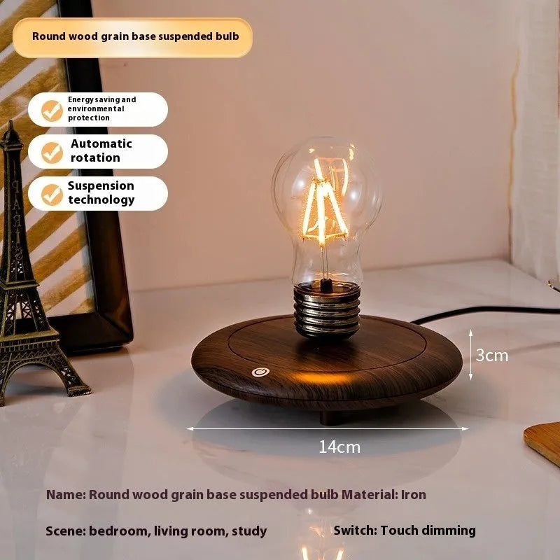 Creative small iron art night lamp with suspension bulb design on a black wood grain base.