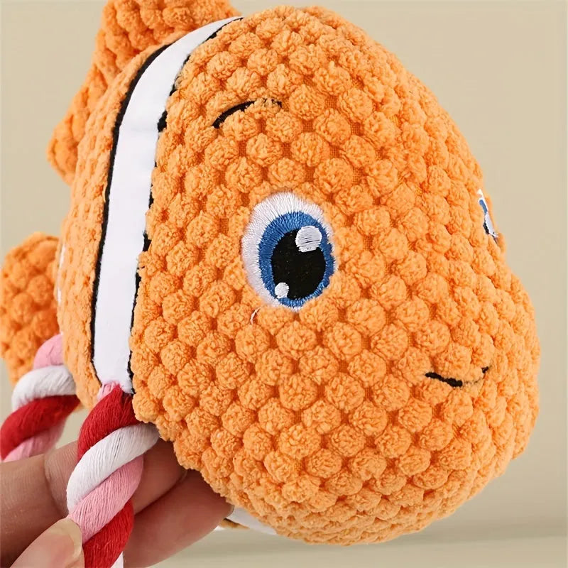 Grey, green, and orange turtle-shaped dog plush toy with a visible textured rope knot centre.