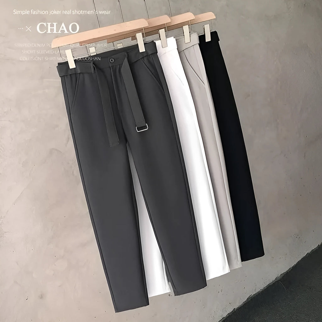 Boy wearing slim straight grey wool trousers with a tapered fit and straight leg opening.