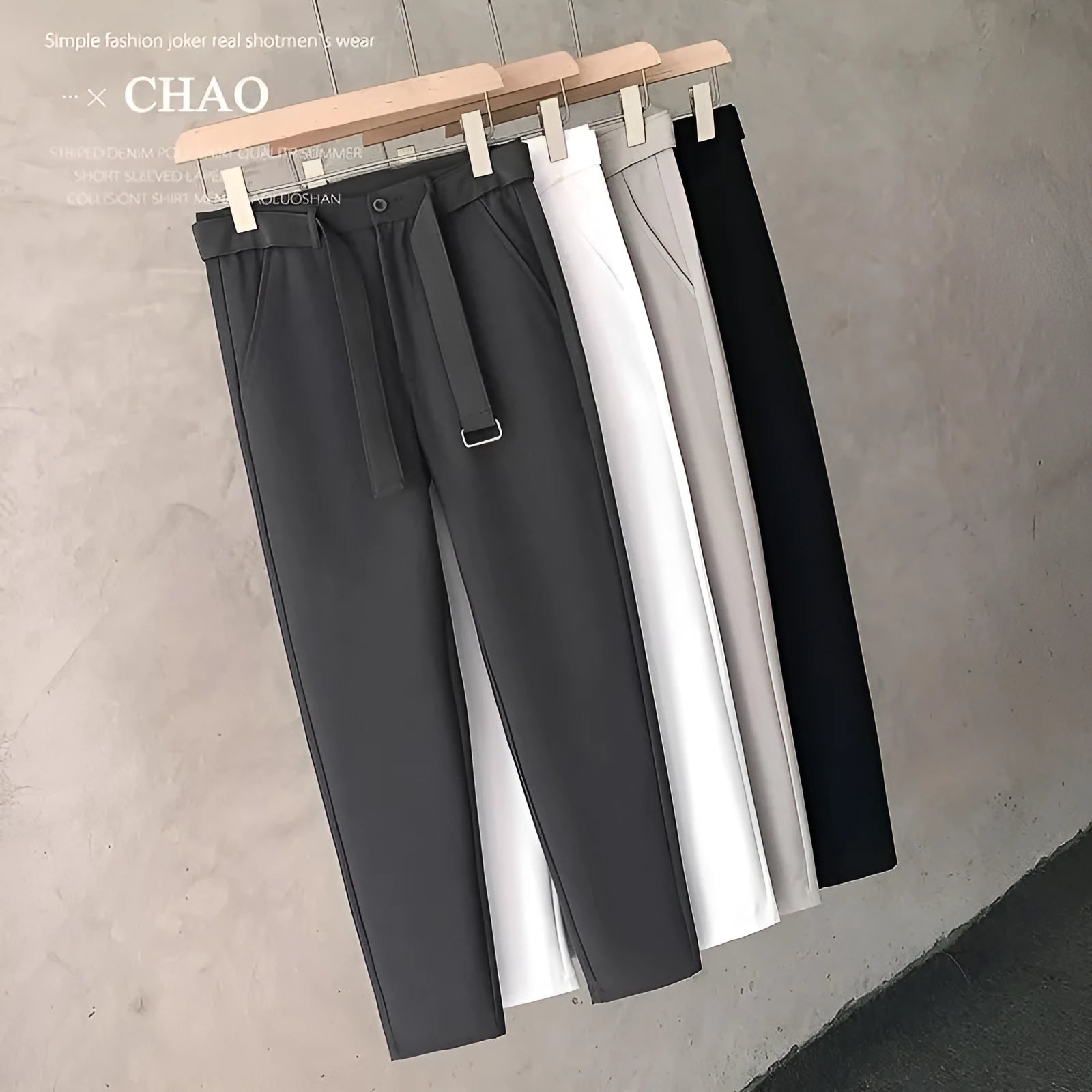 Boy wearing slim straight grey wool trousers with a tapered fit and straight leg opening.