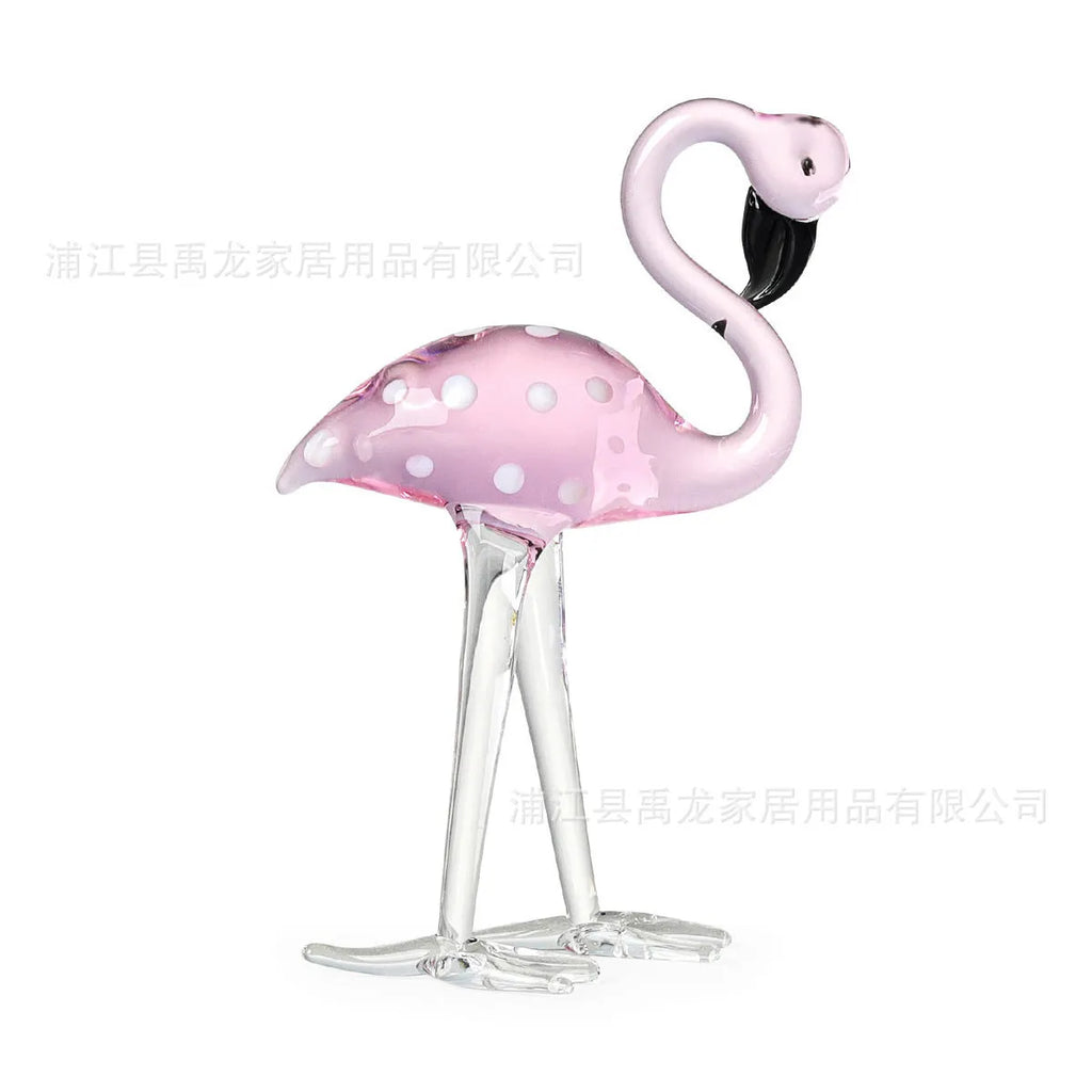 Clear crystal flamingo decorative sculpture with pink dots on a table.