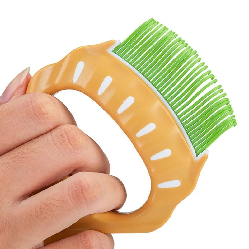 Green shell-shaped pet grooming brush with fine bent wire bristles and an anti-slip handle.