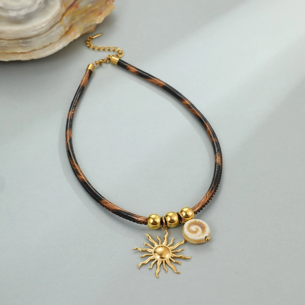Gold plated stainless steel necklace with geometric leopard pendant and adjustable chain on white background