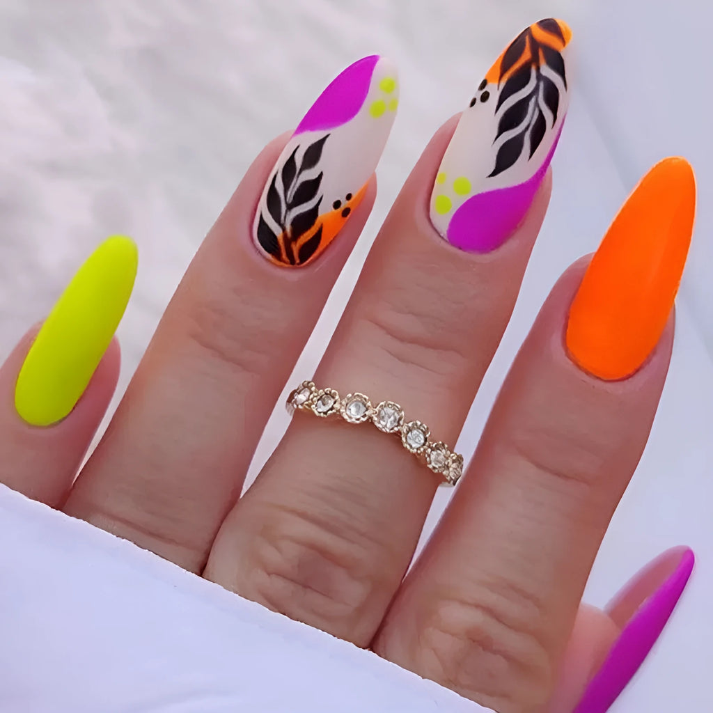 Four boxes of almond-shaped frosted nail stickers showing French leaves, leopard print, macaron and plating designs
