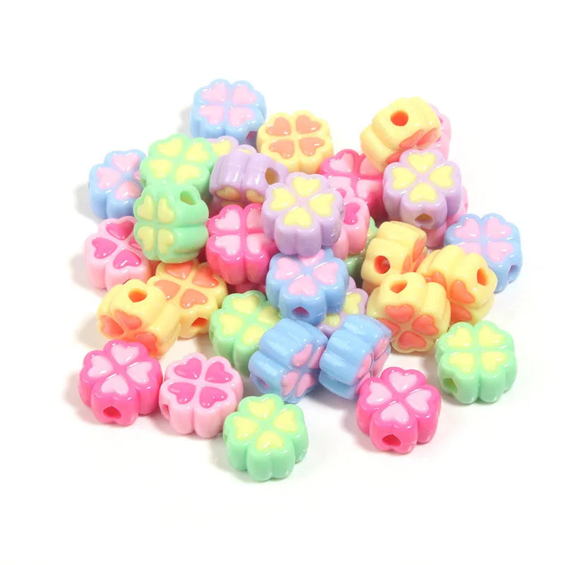 Assorted light-coloured acrylic clover-shaped beads with frosted finish, 15mm size.