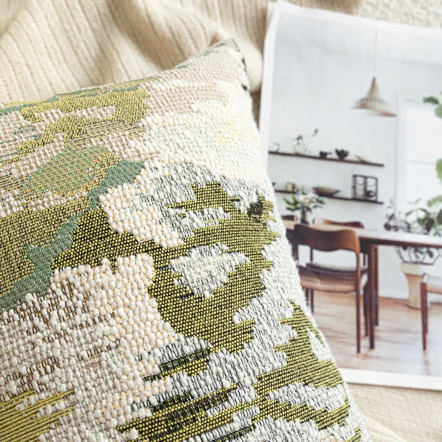 Green abstract floral pattern on a square wool blend decorative cushion pillow.