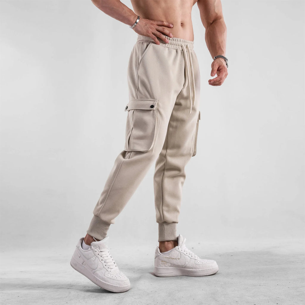 Men's loose fit multi-pocket cotton trousers with ankle ties in apricot colour