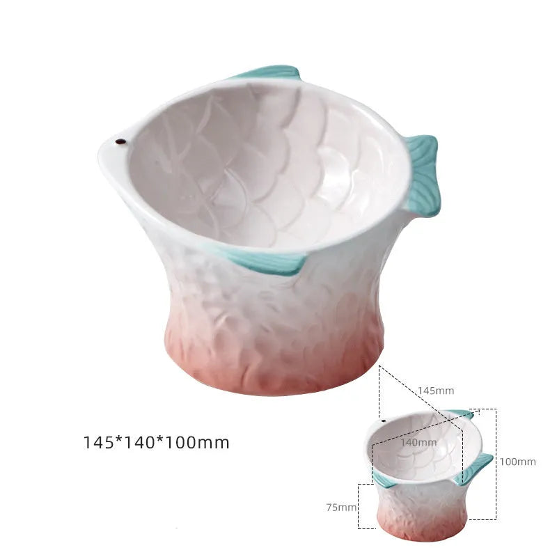 Blue fish-shaped ceramic cat bowl with elevated base and tilted food well
