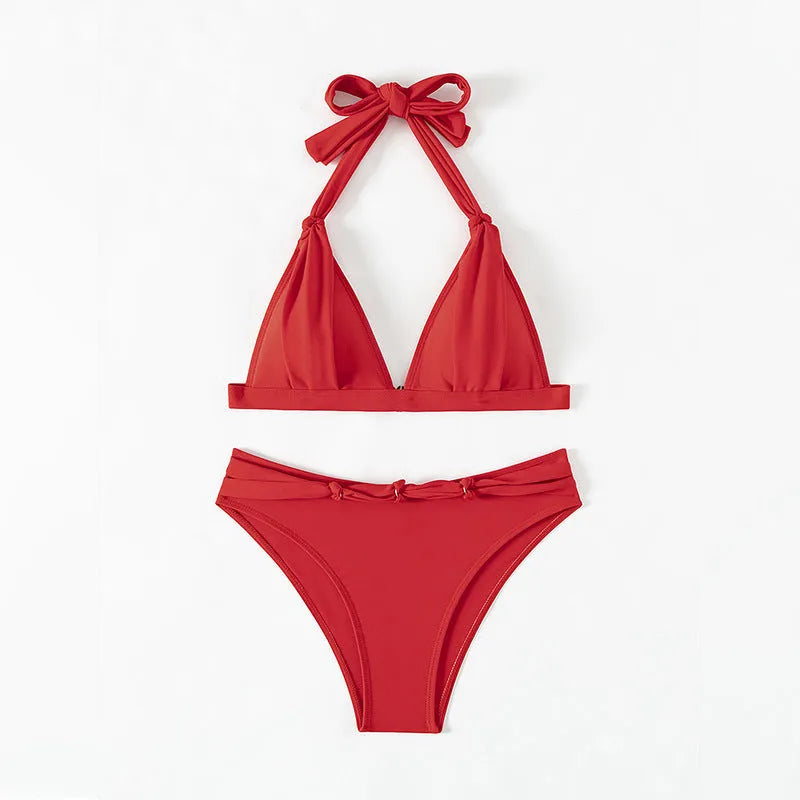 Red women's halterneck lace-up bikini top and shorts set on a mannequin.