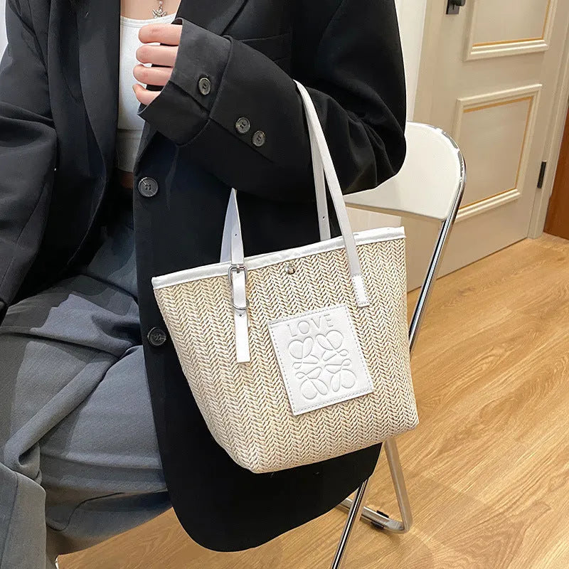 Straw woven women's shoulder bag with 27cm width showing three-dimensional pocket and 18cm handle