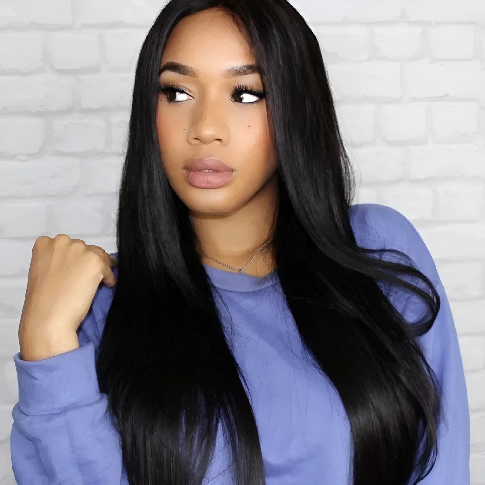 Long straight black wig with centre-parted bangs on wig stand