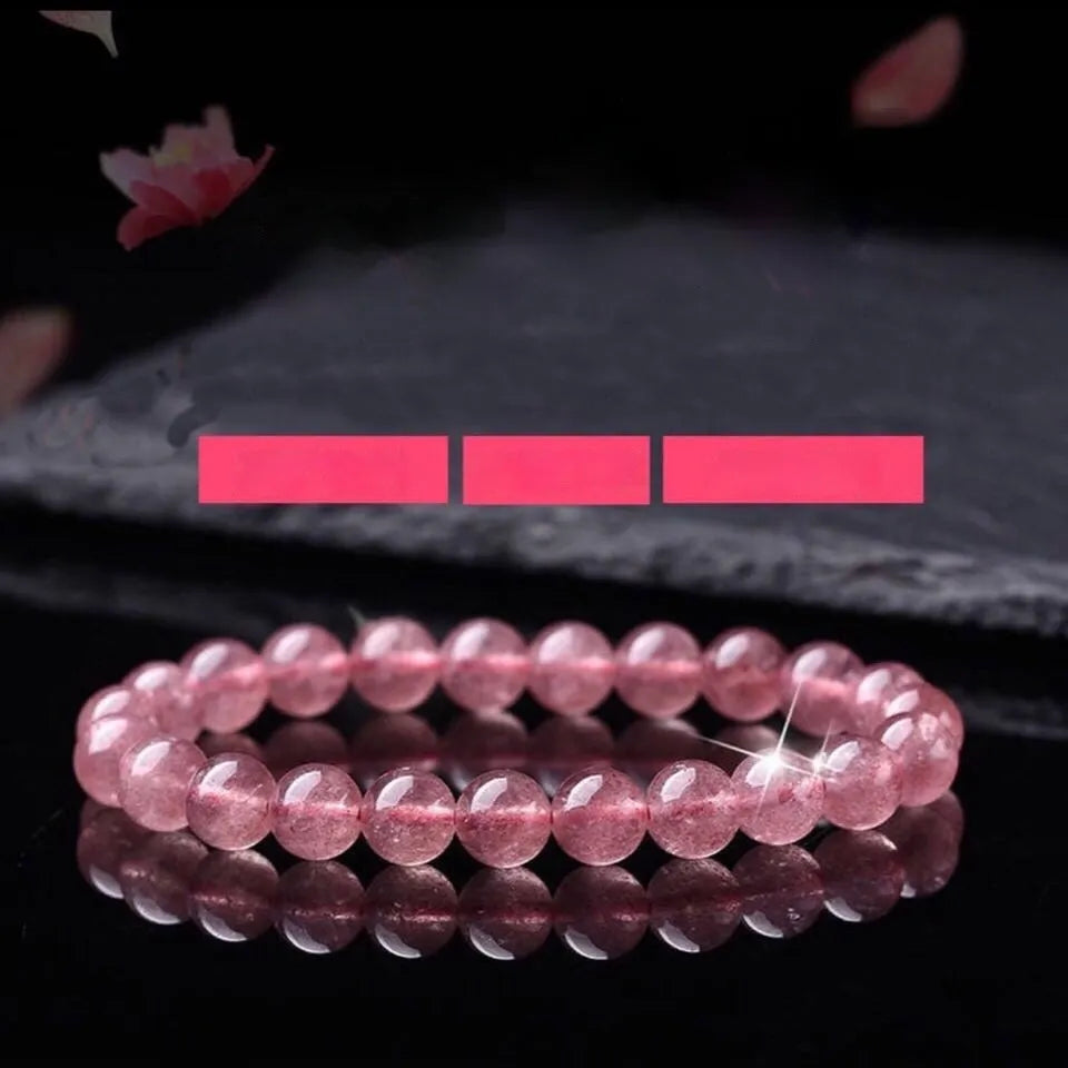 Women's strawberry quartz crystal bracelet showing 10mm, 8mm and 6mm polished beads