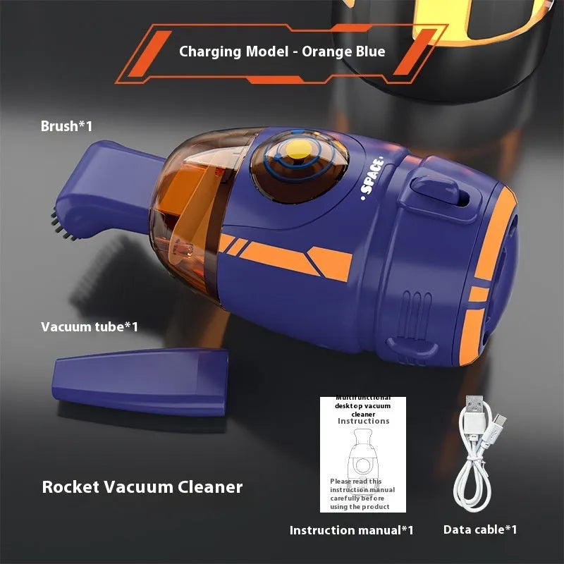 Handheld USB desktop vacuum cleaner in blue rocket design on a wooden desk.