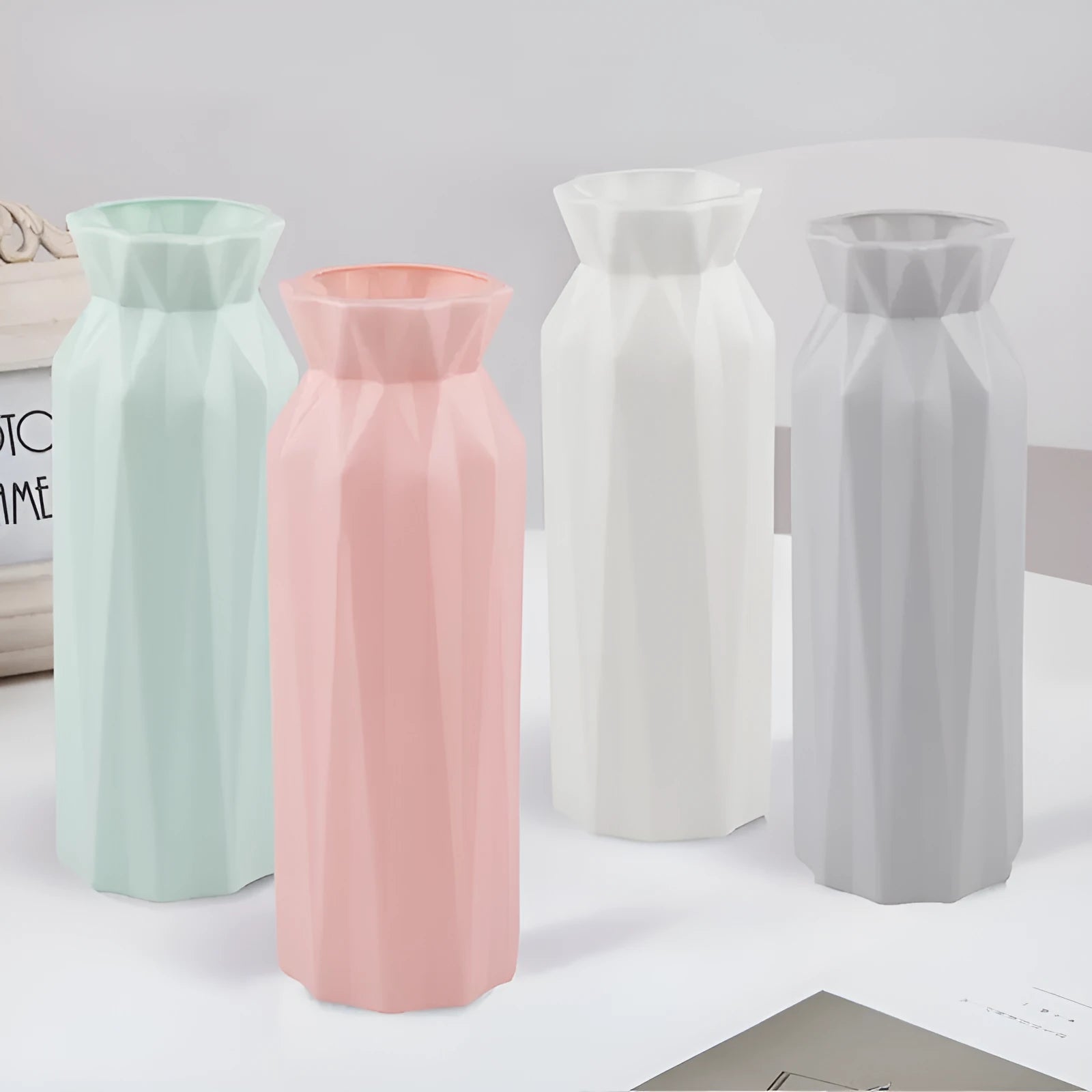 Green melamine plastic vase with a wide 7.2cm base on a wooden table.