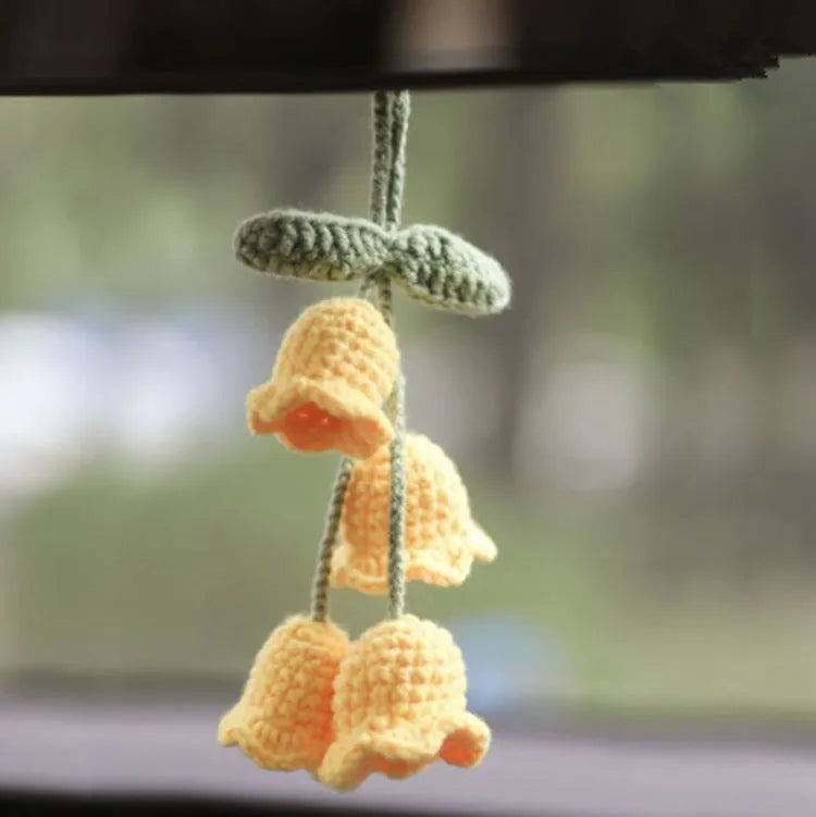 Knitted green and white car plant decoration with hanging rope