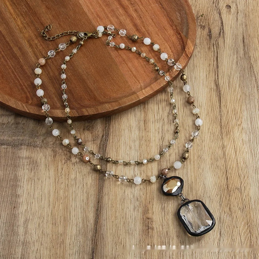 Tribal style two-layer chain necklace with glass and stone pendants in beige and blue colours