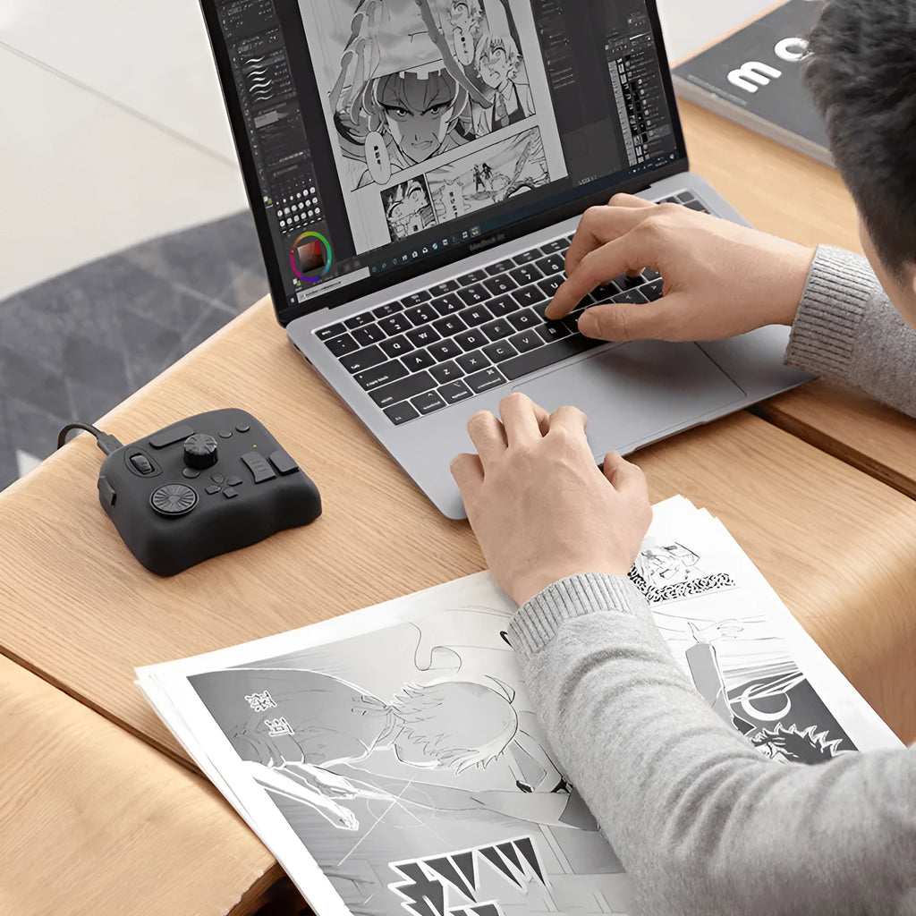 TourBox NEO black creative controller for video editing on a desk next to a tablet.