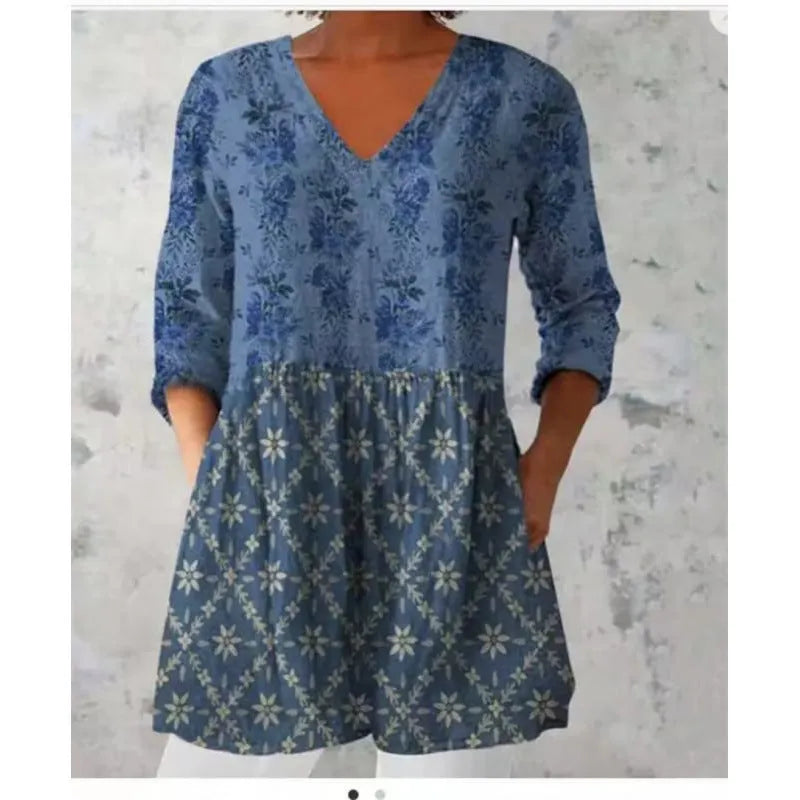 Women's floral printed loose dress with wide waist and three-quarter sleeves on a hanger.