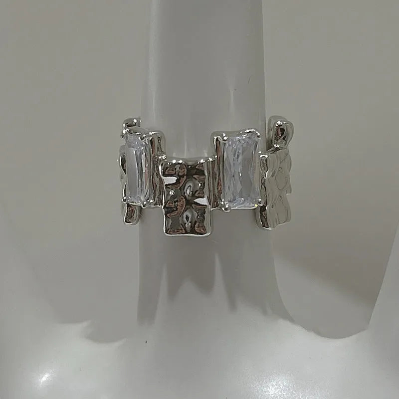 Silver geometric cross zircon ring with open gemstone design and three-dimensional decoration