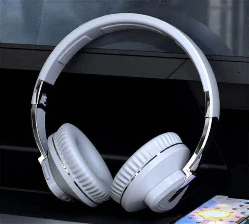 Wireless over-ear headset in black with Bluetooth logo, AUX jack, and TF card slot visible.