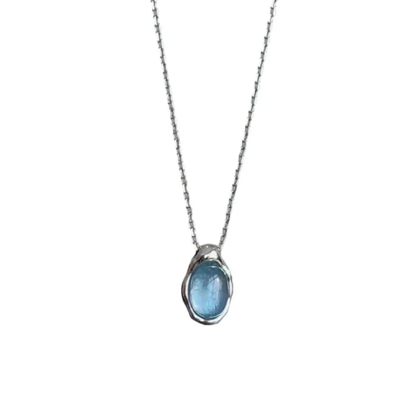 Navy blue geometric water drop pendant necklace with cross chain design on white background