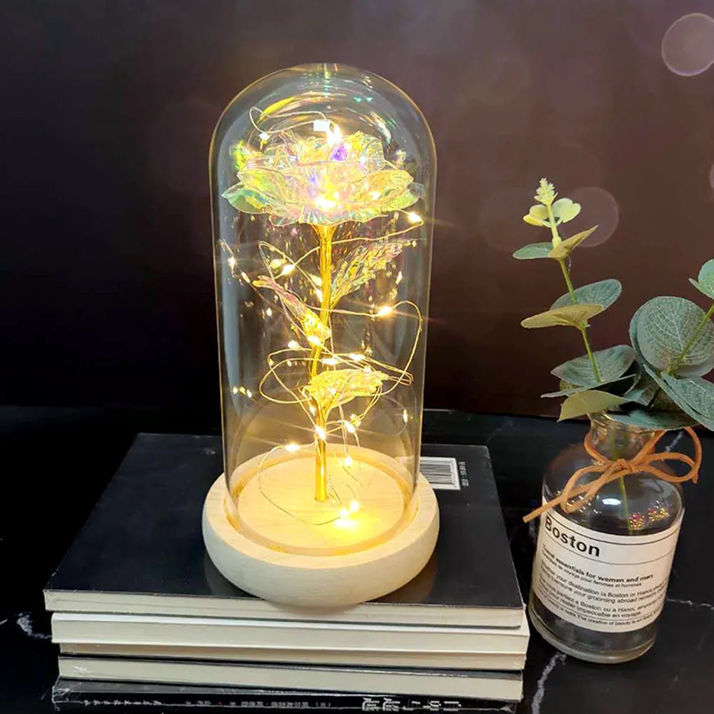 LED silk rose bouquet with glass lampshade glowing with warm white light on a solid wood base.